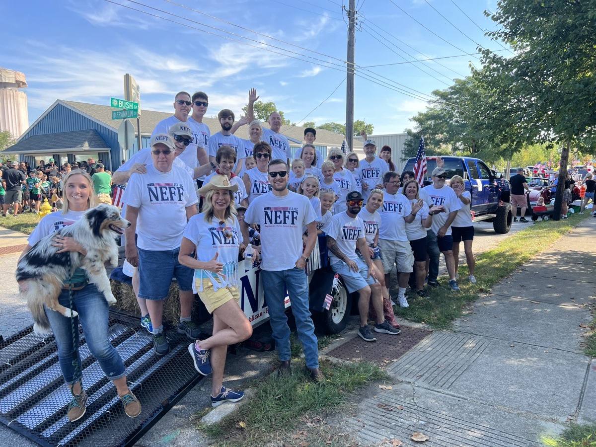 A large group of Team Neff volunteers in matching shirts, with Knox the mascot, on parade day